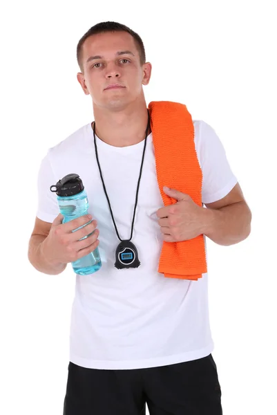 Handsome young sportsman holding towel and bottle with water isolated on white — Stock Photo, Image