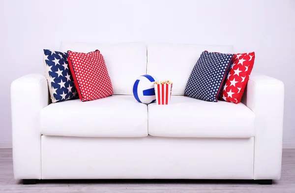 Popcorn and ball on sofa — Stock Photo, Image