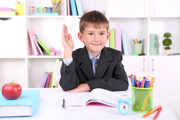 Schoolboy sitting at table — Stock Photo, Image