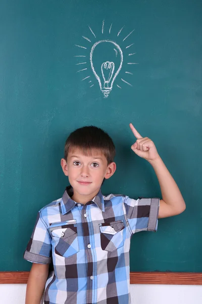 Funny Schoolboy at blackboard — Stock Photo, Image