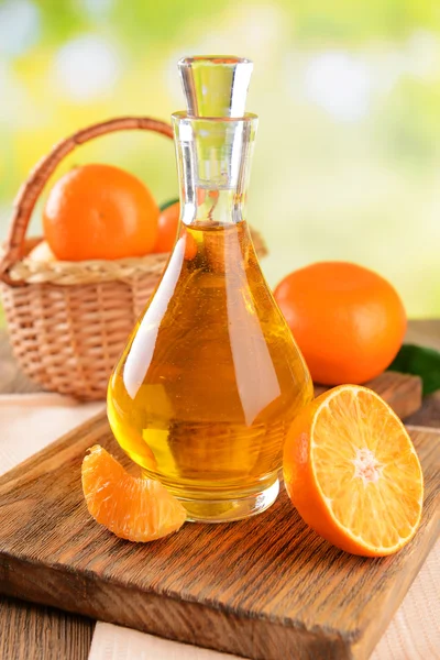 Tangerine oil on table on light background — Stock Photo, Image