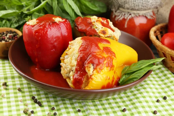 Composition with prepared stuffed peppers on plate and fresh herbs, spices and vegetables, on wooden background — Stock Photo, Image
