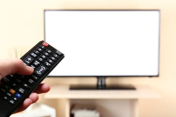 Watching TV with remote controller — Stock Photo, Image