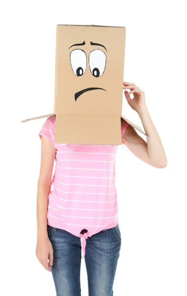 Woman with cardboard box on her head with sad face, isolated on white — Stock Photo, Image