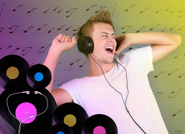 Handsome young man listening to music — Stock Photo, Image