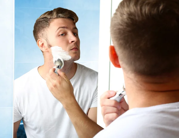 Young man shaving beard — Stock Photo, Image