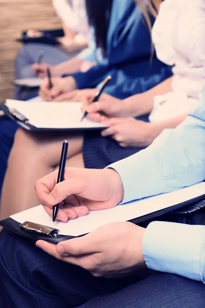 Hands holding pens — Stock Photo, Image