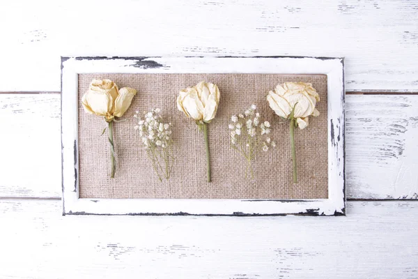 Wooden frame with dried flowers — Stock Photo, Image