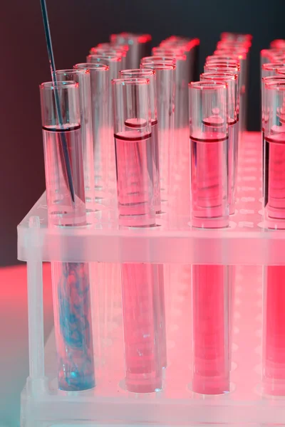Test tubes with liquid on dark background — Stock Photo, Image