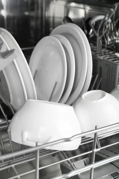 Open dishwasher with clean utensils in it — Stock Photo, Image