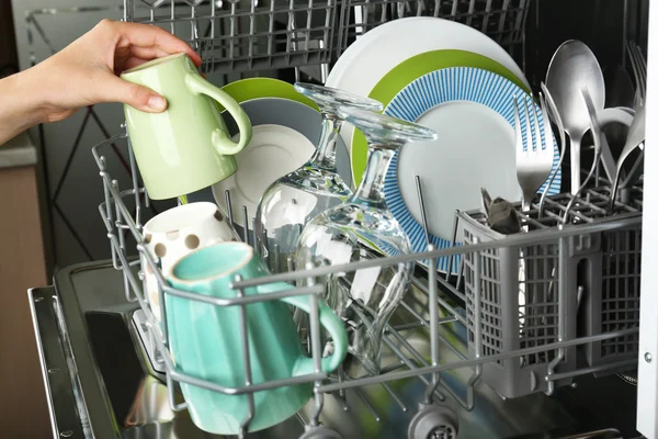 Open dishwasher with clean utensils in it — Stock Photo, Image