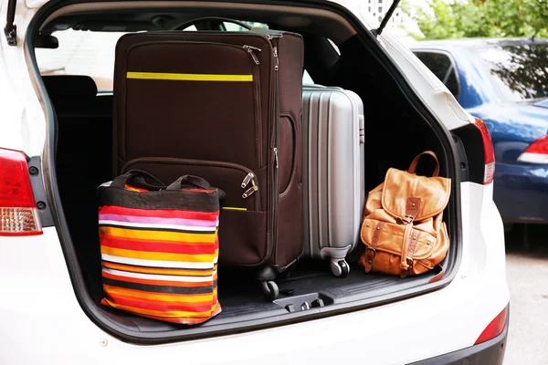 Suitcases and bags in trunk of car ready to depart for holidays — Stock Photo, Image