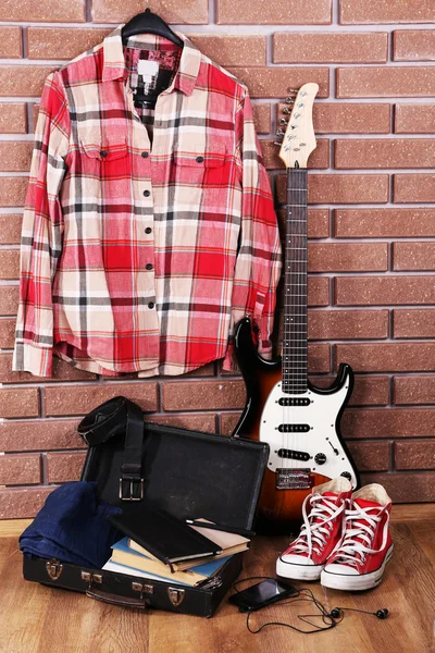 Guitar, clothes, boots and suitcase — Stock Photo, Image