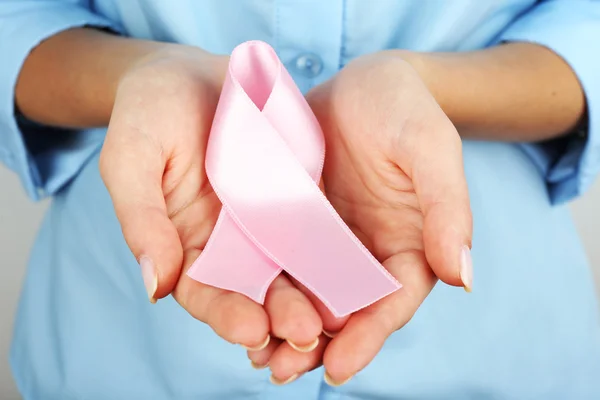 Woman holding pink ribbon — Stock Photo, Image