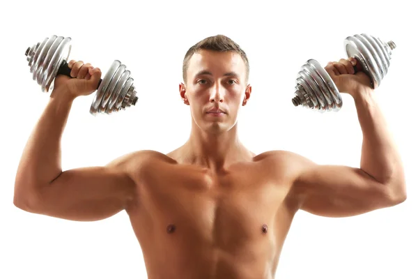 Bonito jovem desportista muscular executar exercício com halteres isolados em branco — Fotografia de Stock