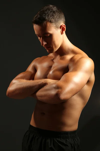 Handsome muscle young man on dark background — Stock Photo, Image