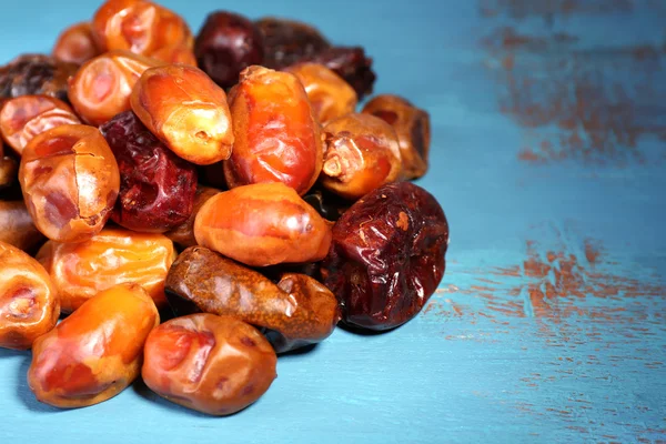 Tasty dates fruits on blue wooden table — Stock Photo, Image
