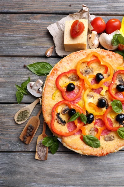 Delicious pizza served on wooden table — Stock Photo, Image