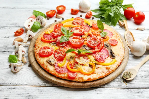 Lahodná pizza podávaná na dřevěném stole — Stock fotografie