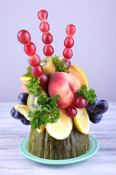 Table decoration made of fruits on grey wooden table on grey background — Stock Photo, Image