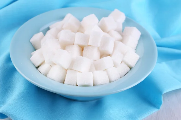 Refined sugar in color bowl on wooden background — Stock Photo, Image