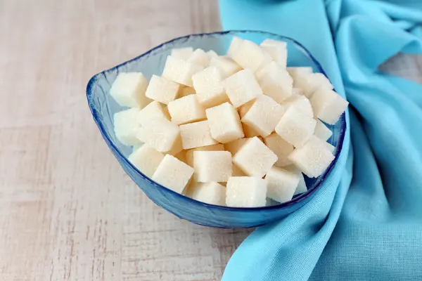 Refined sugar in color bowl on wooden background — Stock Photo, Image