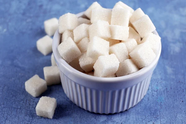 Refined sugar in bowl on color wooden background — Stock Photo, Image