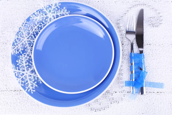 Blue plates, knife, fork, napkin and Christmas decoration on wooden background — Stock Photo, Image