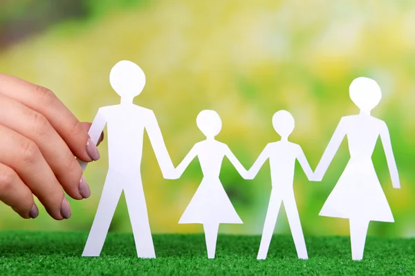 Hand holding paper family — Stock Photo, Image
