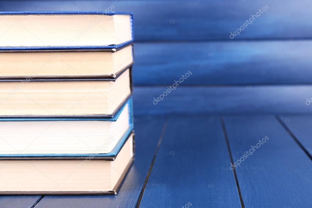 Books on dark blue wooden background