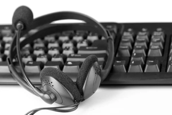 Headphone and keyboard on white — Stock Photo, Image