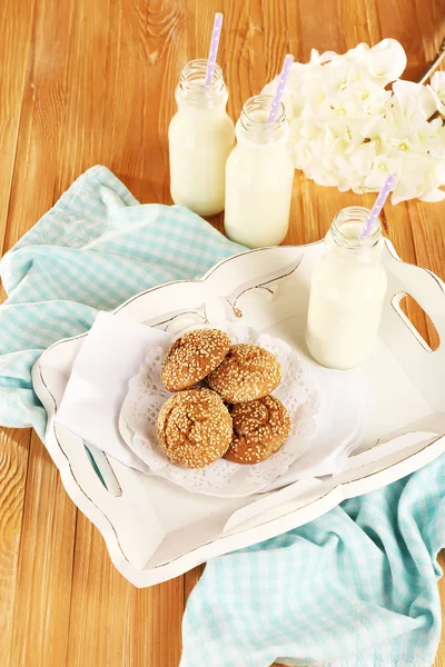 Milk and cookies on tray on table — Stock Photo, Image