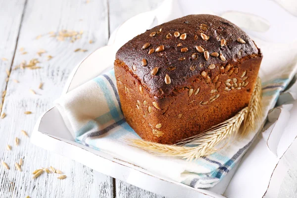 Fresh bread on wooden table — Stock Photo, Image