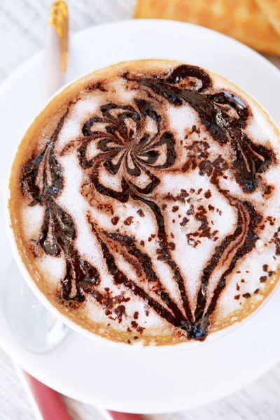 Cup of coffee with cute drawing on table, close up — Stock Photo, Image