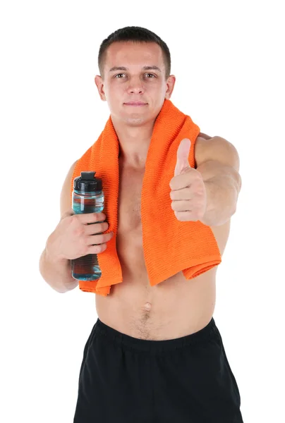 Handsome young sportsman holding towel and bottle with water isolated on white — Stock Photo, Image