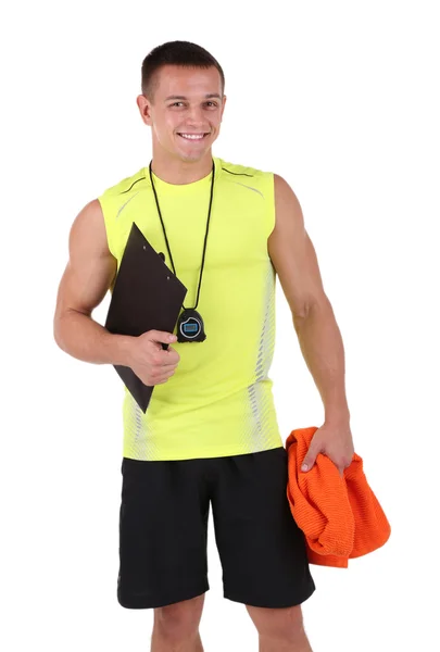 Handsome young sportsman holding clipboard and towel isolated on white — Stock Photo, Image