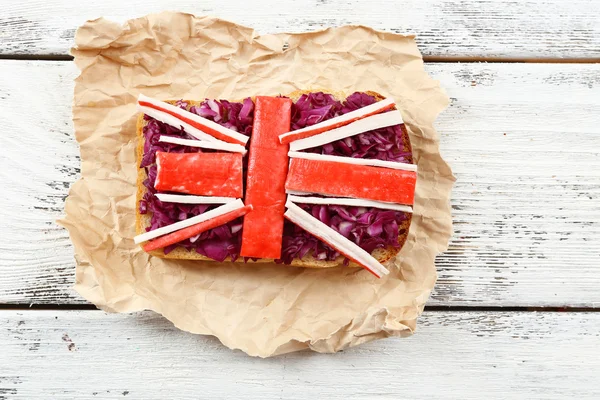 Sandwich with flag of Great Britain on table close-up — Stock Photo, Image