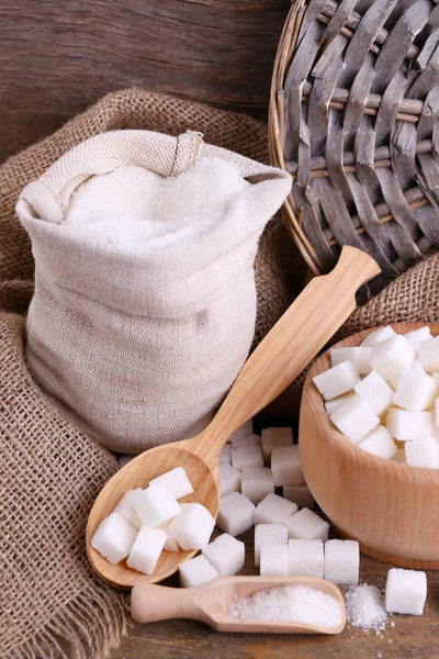 Refined sugar in bag and bowl on wooden background — Stock Photo, Image