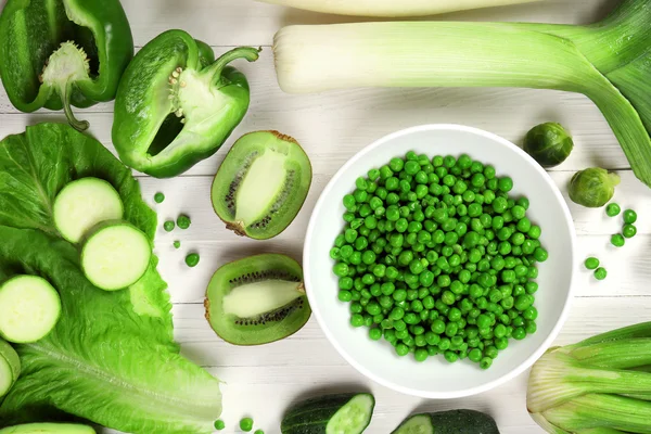 Fresh organic vegetables and fruits on wooden table, close up — Stock Photo, Image