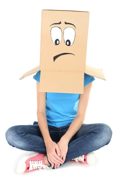 Woman with cardboard box on her head with sad face, isolated on white — Stock Photo, Image