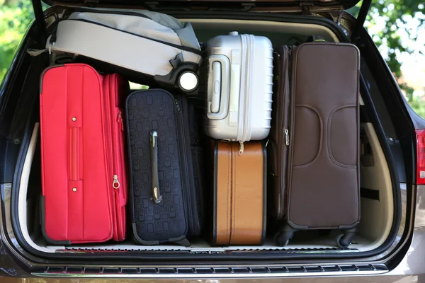 Suitcases and bags in trunk of car — Stock Photo, Image