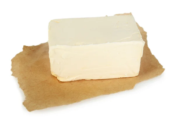 Manteiga fresca sobre papel, isolada sobre branco — Fotografia de Stock