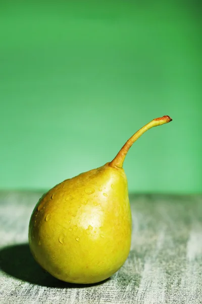 Ripe tasty pear, on wooden table — Stock Photo, Image