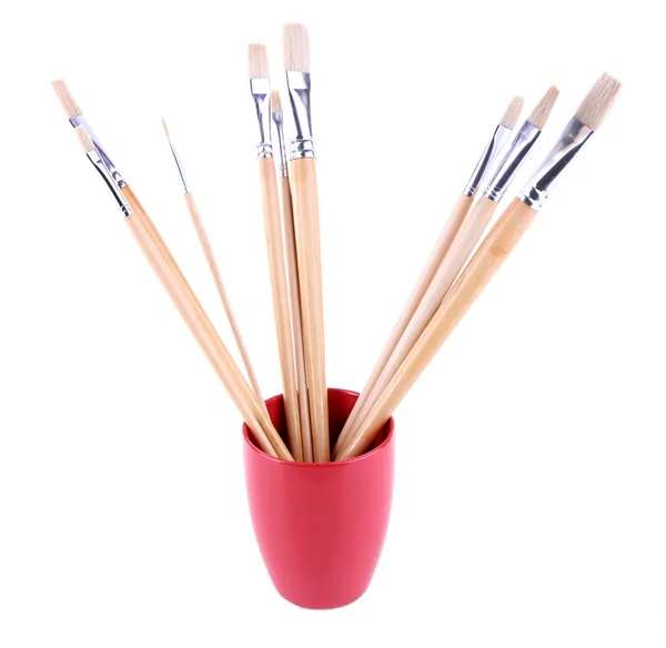 Paint brushes in red mug — Stock Photo, Image