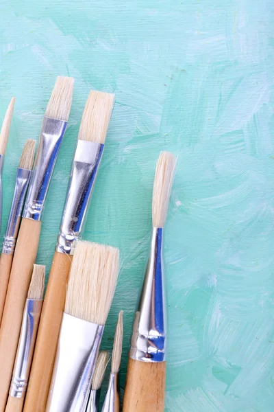 Paint brushes on blue — Stock Photo, Image