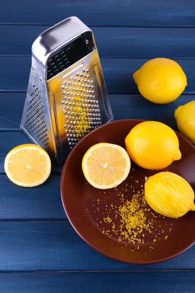 Lemons on plate and grater — Stock Photo, Image