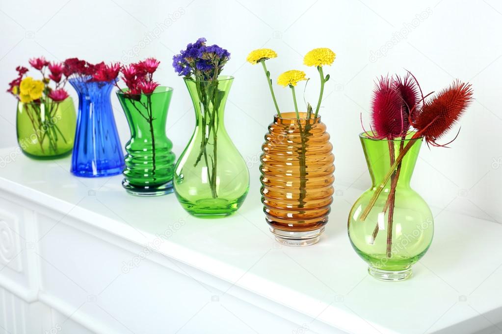Colorful vases on white table