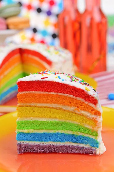 Вкусный радужный торт на тарелке на светлом фоне — стоковое фото