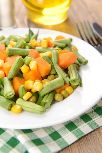 Delicious vegetables salad on plate on table close-up — Stock Photo, Image