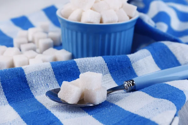 Refined sugar in color bowl on color napkin background — Stock Photo, Image